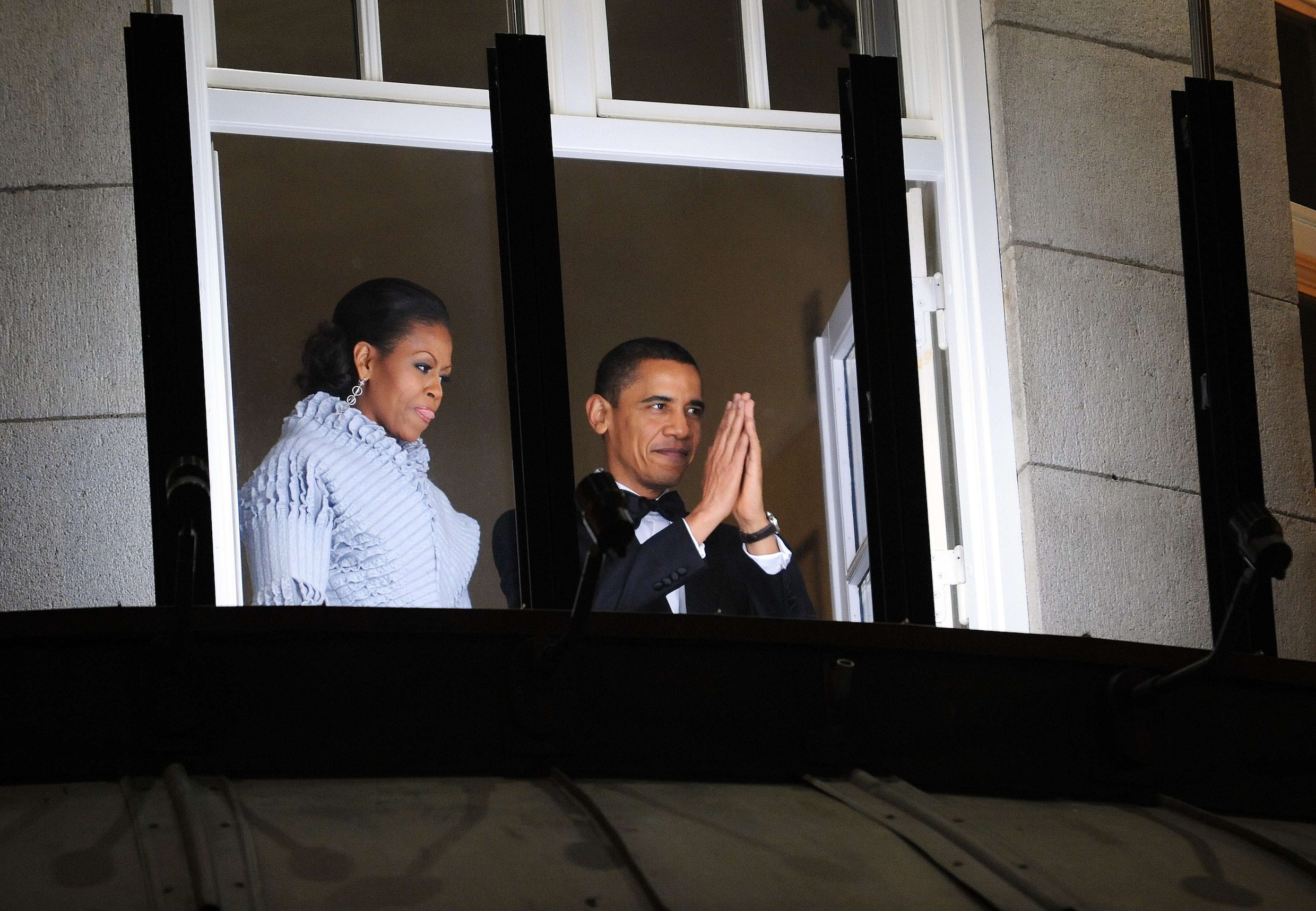 10 december 2009: kersvers Nobelprijs-winnaar Barack Obama en zijn vrouw Michelle groeten vanaf het balkon van hun hotel in Oslo de mensen die meelopen met een fakkeloptocht ter ere van de VS-president.